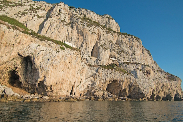 Close-up view of the property from the sea with Gorham’s Cave in the foreground and Vanguard and Hyaena caves behind.