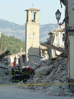 Firefighters gather near the damaged Sant'Agostino church in the central Italian village of Amatrice on 26 August, 2016, three days after a 6.2-magnitude earthquake struck the region. ANDREAS SOLARO/AFP/Getty Images