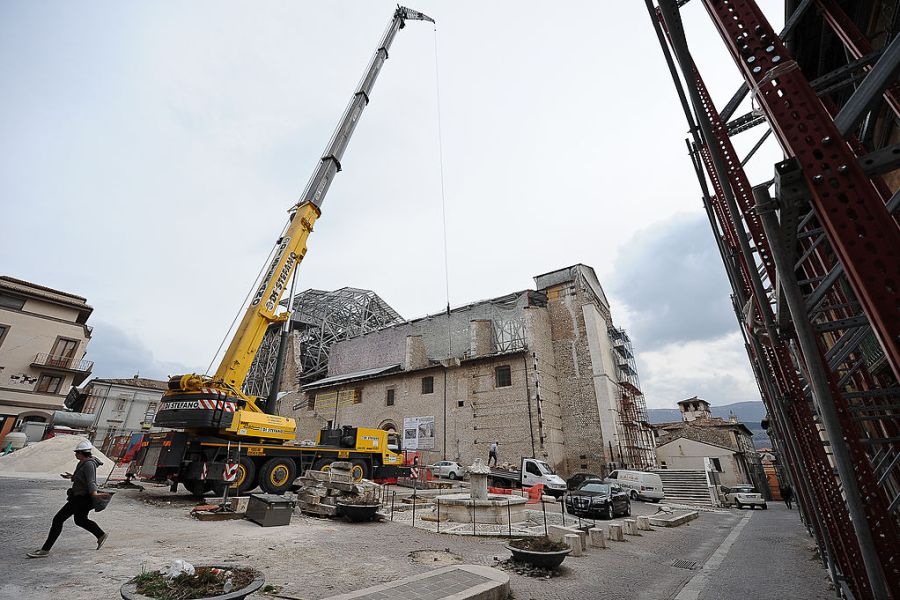 Apeopla pass on 2 April, 2012, by the Santa Maria Paganica church near the 'red zone' closed to public, in the historic area of L'Aquila devastated by the 2009 earthquake. ANDREAS SOLARO/AFP/Getty Images