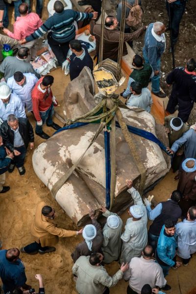 Egyptian workers excavate the statue, recently discovered by a team of German-Egyptian archeologists, in Cairo's Mattarya district on March 13, 2017.