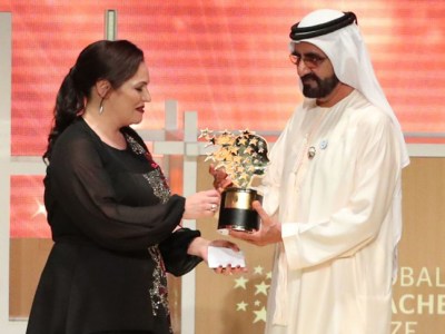 Andria Zafirakou receives the 'Global Teacher Prize' from Sheikh Mohammed bin Rashid al-Maktoum, Vice-President and Prime Minister of the UAE and Ruler of Dubai during an award ceremony in Dubai on 18 March 2018.