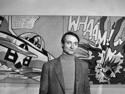 Roy Lichtenstein in front of one of his paintings at the Tate Gallery, London.