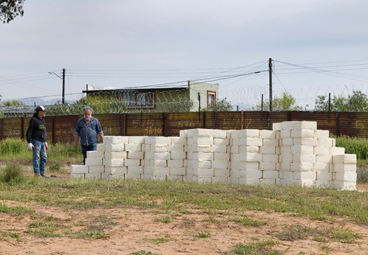 Artist Cosimo Cavallaro building his wall of cheese.