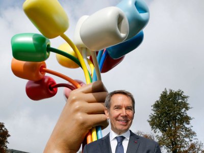 Jeff Koons poses in front of his Bouquet of Tulips in Paris on 4 October 2019.