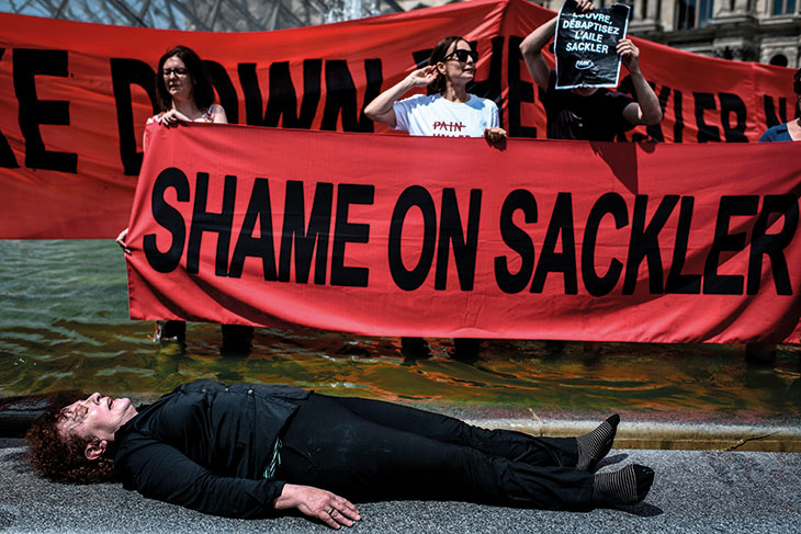 Nan Goldin protesting with P.A.I.N. in the courtyard of the Louvre in July 2019.