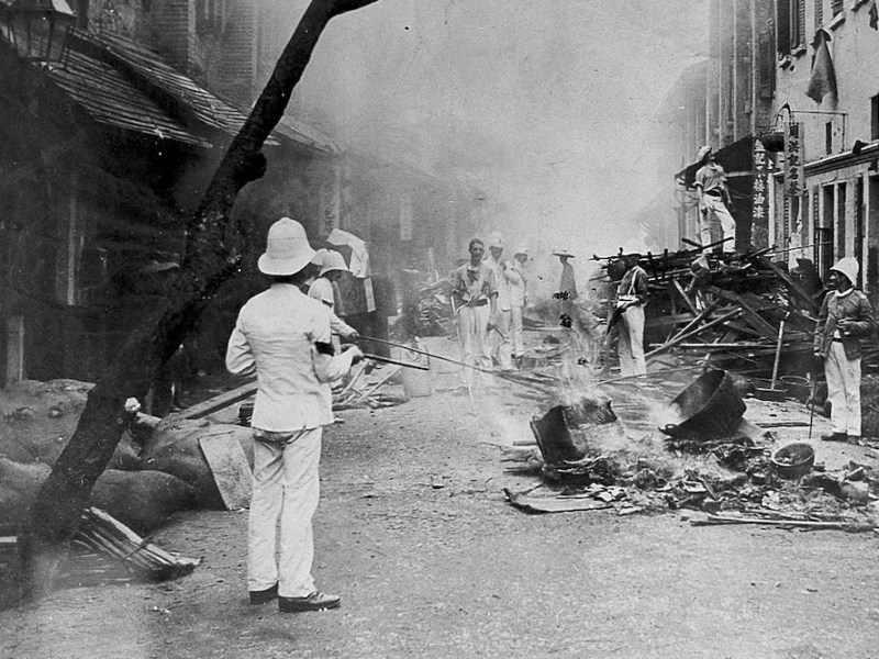 Shropshire Regiment ‘Whitewash Brigade’ emptying items from Chinese homes in Taipingshan, Hong Kong, and burning them on the street as an epidemic control measure during the 1894 plague outbreak.