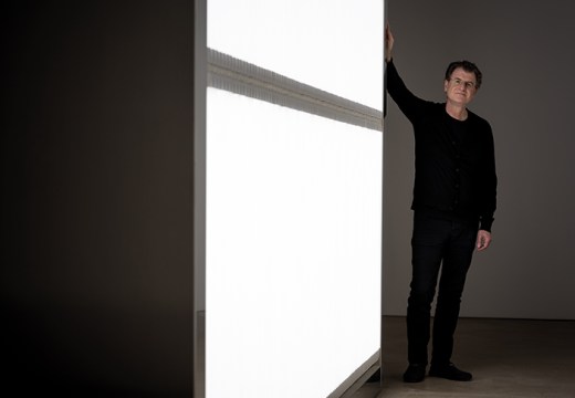 Alfredo Jaar photographed next to his installation ‘The Sound of Silence’ (2006) at Yorkshire Sculpture Park in October 2017. Photo by Jonty Wilde