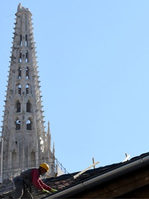 A builder works on the roof of the south tower of Zagreb's cathedral in April 2020 following the 5.3-magnitude earthquake in downtown Zagreb on 22 March. Photo: DENIS LOVROVIC/AFP via Getty Images