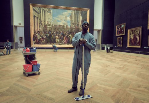 Omar Sy as Assane Diop in 'Lupin', with Veronese's 'Wedding Feast at Cana' in the background.