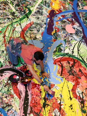 Art attack: Sacha Jafri painting his record- (and potentially back-) breaking artwork.