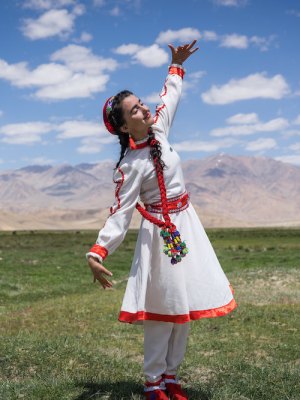 A girl in traditional Tajik dress dances at the opening of a new tourism centre in Bulunkul, Tajikistan (2019), Christopher Wilton-Steer.