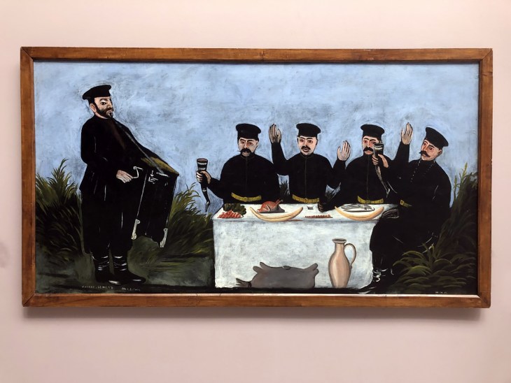 Feast with Datiko Zemel, the Organ Grinder (n.d.), Niko Pirosmani. Georgian National Museum, Shalva Amiranashvili Museum of Fine Arts, Tbilisi.