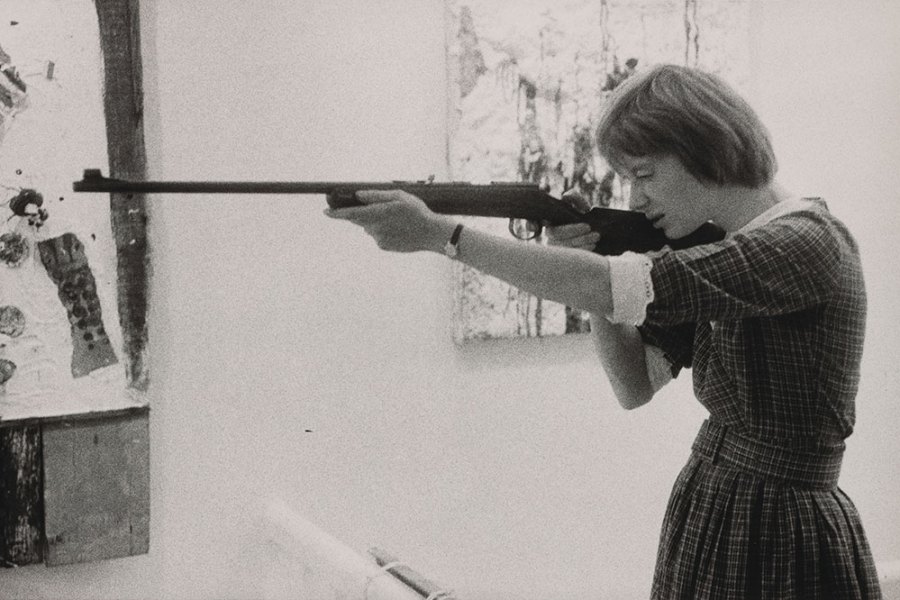 Niki de Saint-Phalle taking aim at her Feu à Volonté at Galerie J in Paris, in 1961.