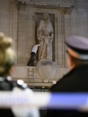 Up to the Gill – an activist with a hammer scales the BBC’s Broadcasting House. Photo: Leon Neal/Getty Images