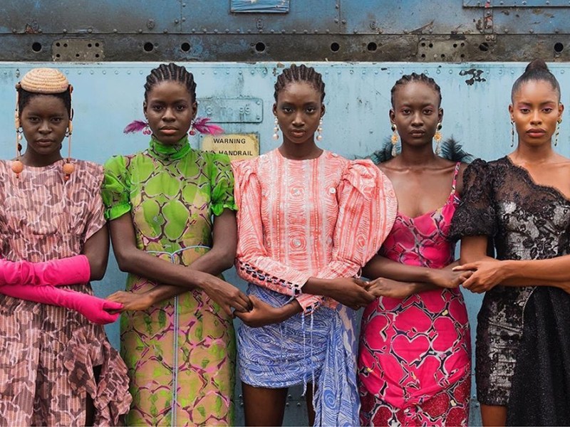 Models hold hands during Lagos Fashion Week. Courtesy Lagos Fashion Week; photo: Stephen Tayo