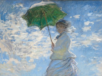 From low on a hillside, we look up at a light-skinned woman and boy standing in tall grass against a sunny blue sky in this vertical painting. The woman stands at the center of the composition, and the moss-green parasol she holds over her head almost brushes the top edge of the canvas. Her body faces our left but she turns her head to look at us. Her long dress is painted largely with strokes of pale blue and gray with a few touches of yellow. Her voluminous skirts swirl around her legs to our left. She holds the parasol with both hands, and her brown hair is covered with a hat. Long strokes of white paint across her face suggest a veil fluttering in the breeze. The tall grass she stands in is dotted with buttercup yellow and plum purple, and she casts a long diagonal shadow along the grass toward us. The young boy seems to stand on the other side of the hill, since the grass and flowers comes up to his waist. He wears a white jacket and pale yellow straw hat. His arms are by his sides, and he seems to look off into the distance to our left. A sunny blue sky behind the people is dotted with bright blue clouds. The painting is created with loose brushstrokes throughout, and they are especially choppy in the clouds. The artist signed and dated the painting in royal-blue letters at the lower right: “Claude Monet 75.” This description was taken from the website of the National Gallery of Art in Washington, D.C.